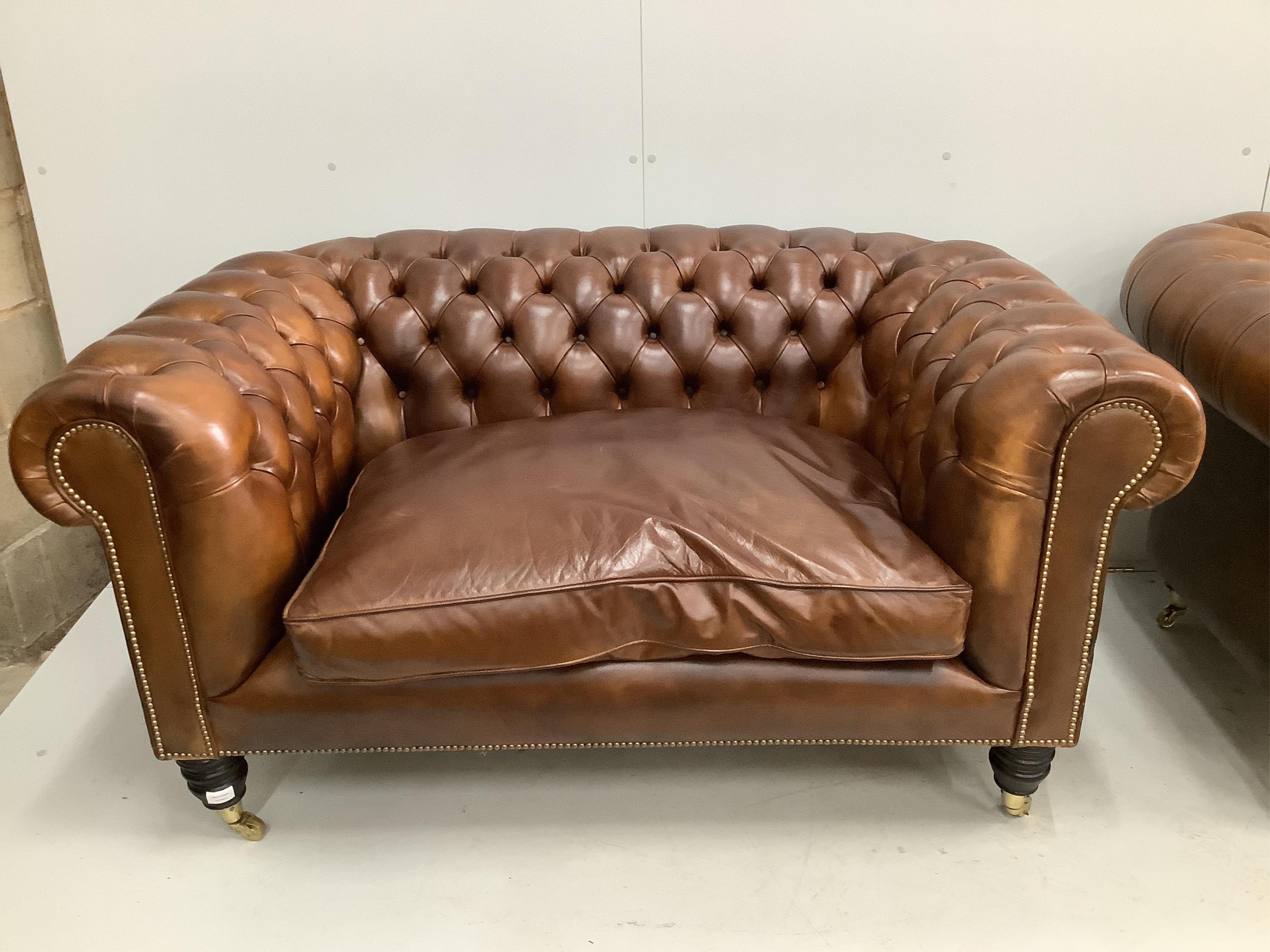 A pair of modern Victorian style buttoned tan leather small Chesterfield settees, width 154cm, depth 88cm, height 78cm. Condition - good